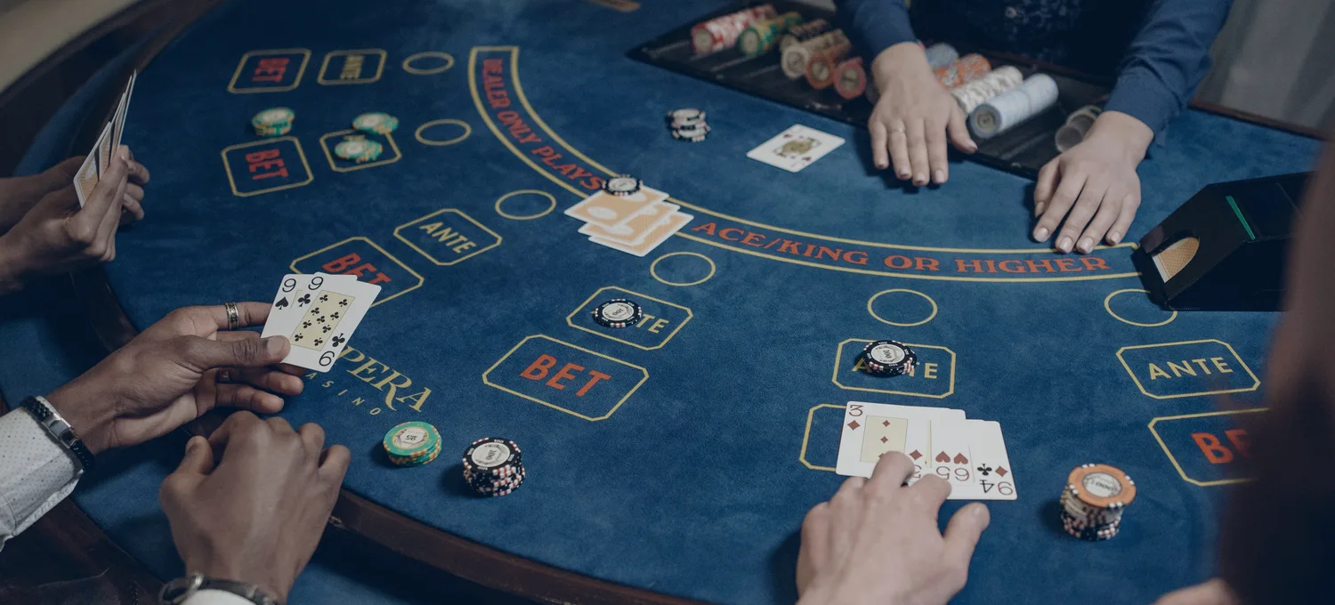 Smartphone showing a card game in a dark blue-lit room
